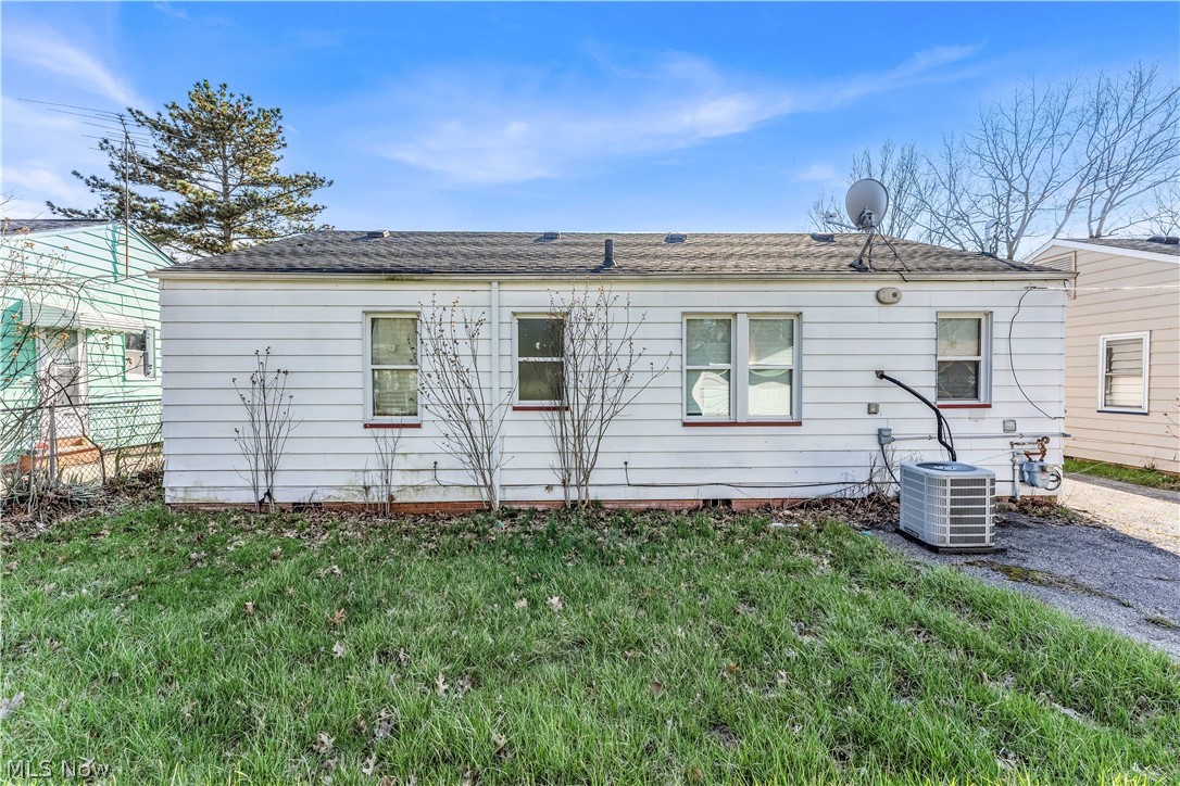 2521 Greenvale Road Cleveland, OH 44121 - Photo 22 of 23 Rear exterior with white siding and a dark shingle roof