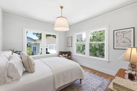 a bedroom with a bed and a chandelier