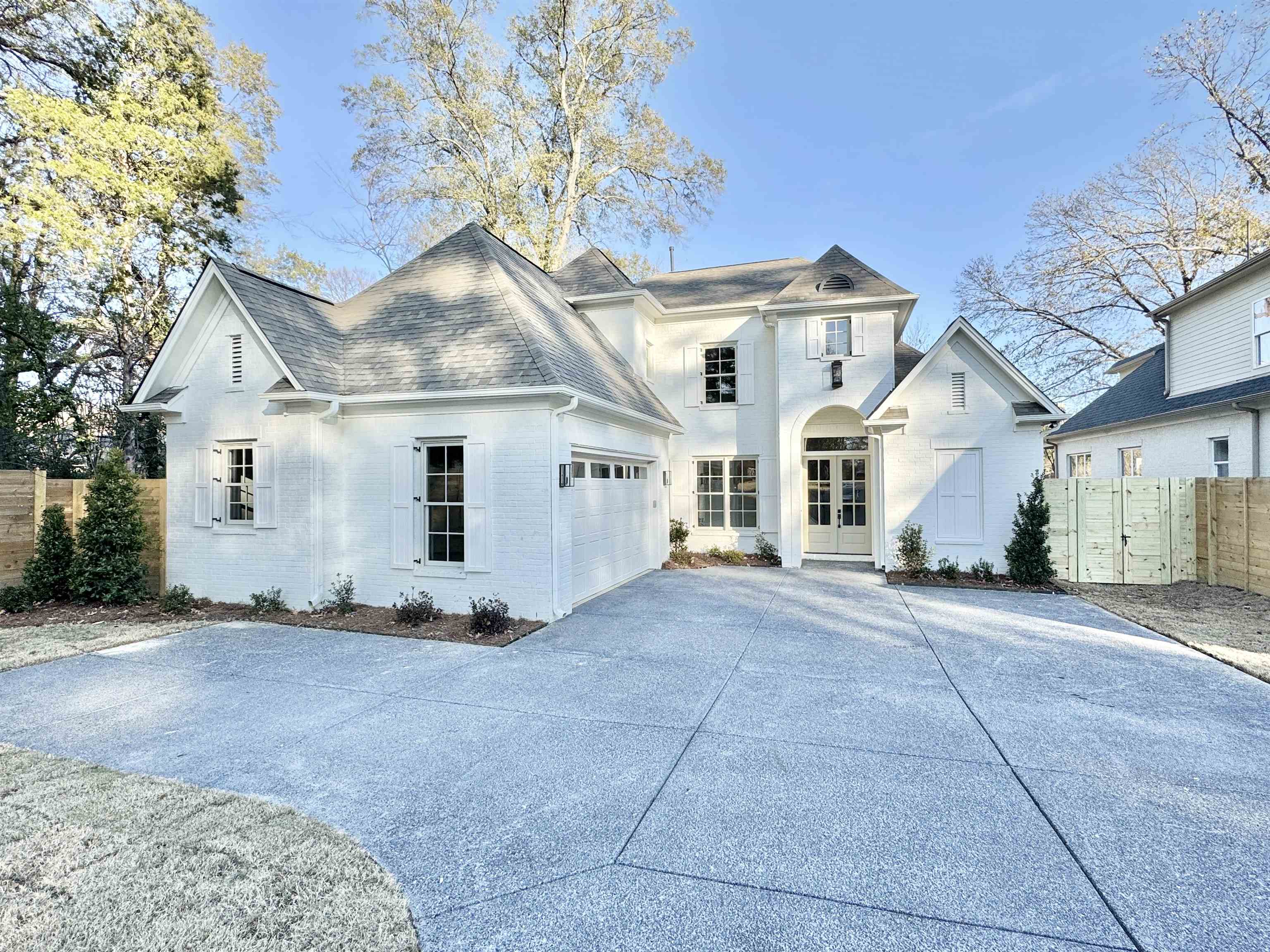 View of front of house featuring brick siding, driveway, and an attached garage
