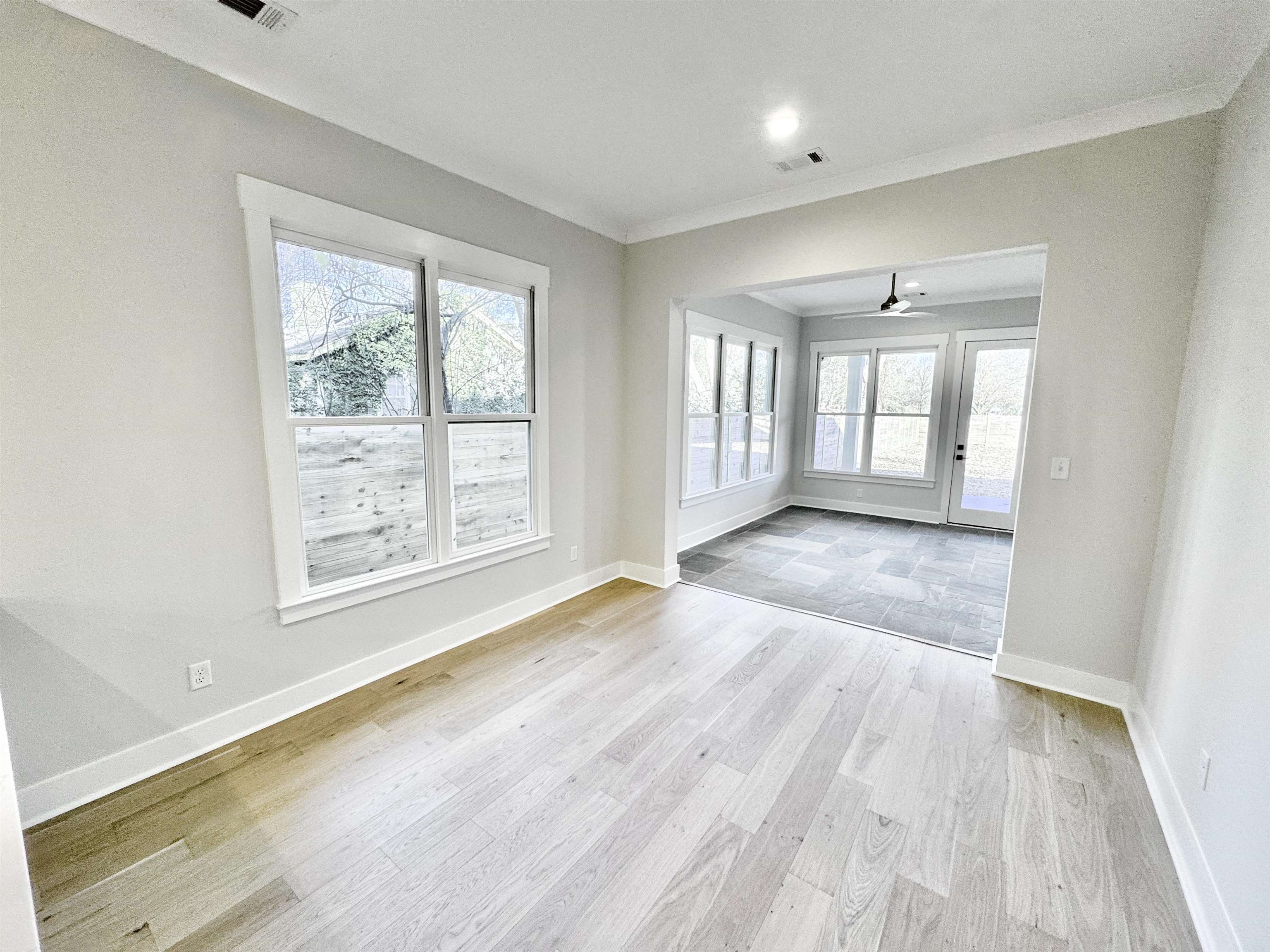 354 Avon Road Memphis, TN 38117 - Photo 14 of 40 Unfurnished living room featuring light wood finished floors, healthy amount of natural light, ornamental molding, and a ceiling fan