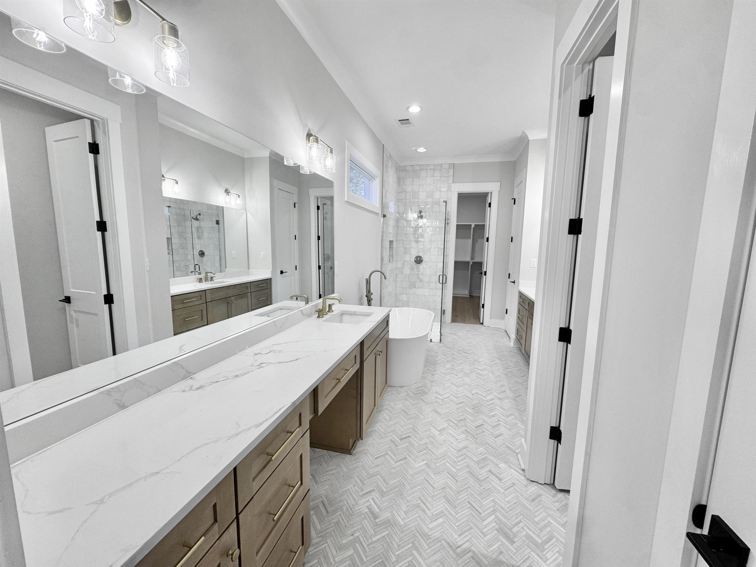 354 Avon Road Memphis, TN 38117 - Photo 19 of 40 Bathroom featuring vanity, a shower stall, a freestanding tub, and a walk in closet