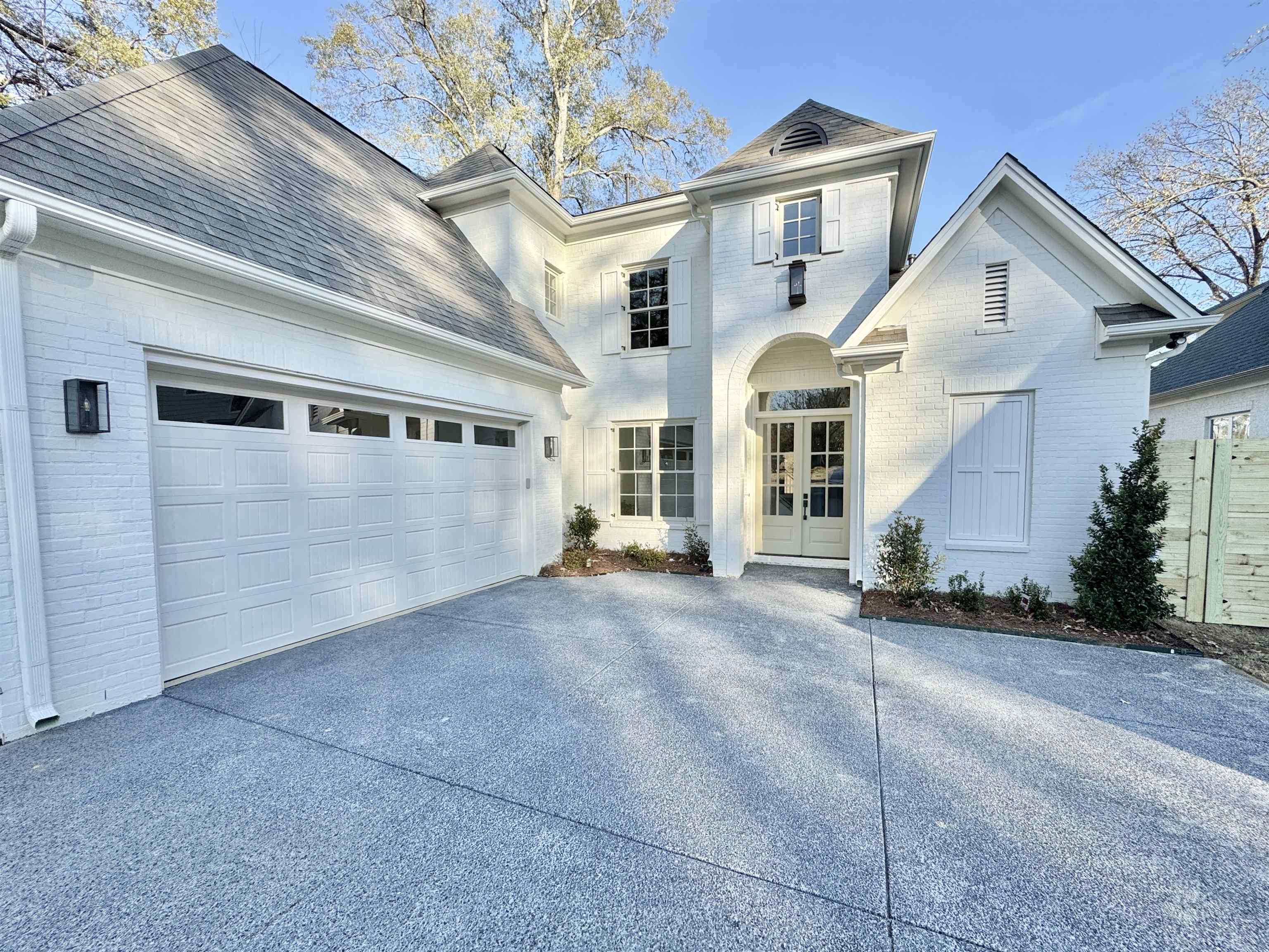 354 Avon Road Memphis, TN 38117 - Photo 2 of 40 Traditional home featuring brick siding, driveway, french doors, an attached garage, and roof with shingles