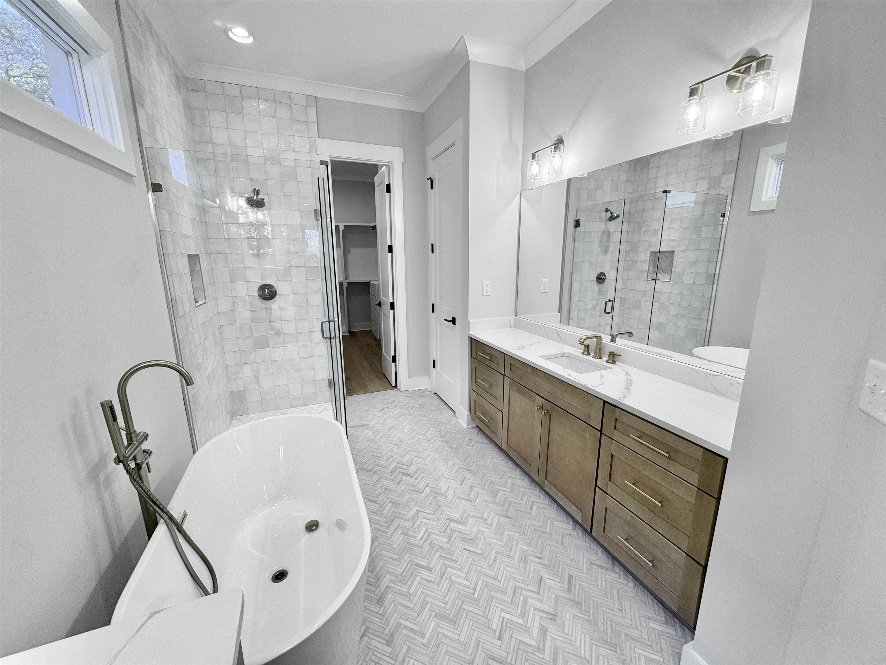 354 Avon Road Memphis, TN 38117 - Photo 21 of 40 Bathroom featuring vanity, crown molding, a freestanding bath, and a stall shower