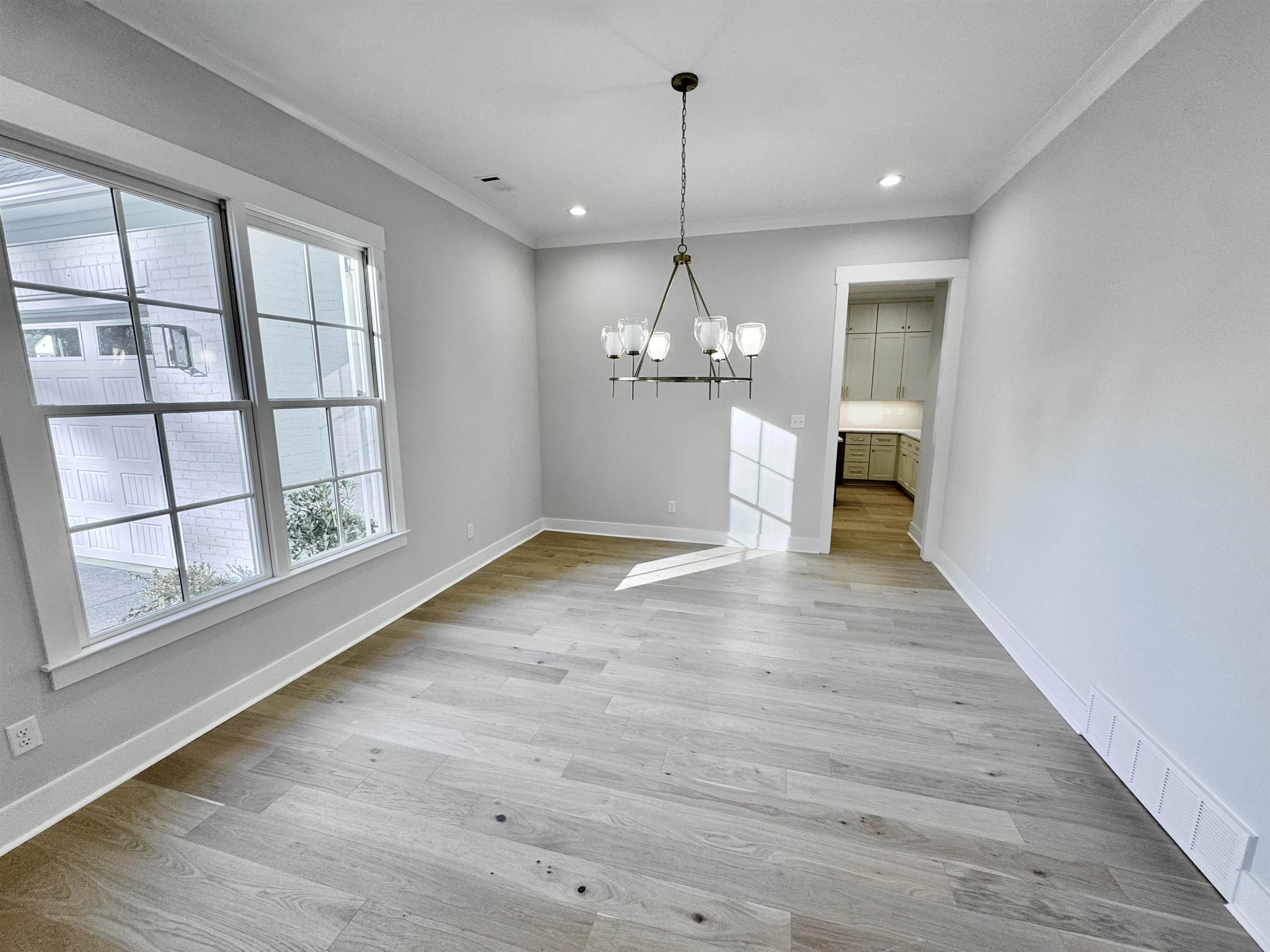 354 Avon Road Memphis, TN 38117 - Photo 24 of 40 Unfurnished dining area with a chandelier, light wood finished floors, crown molding, and recessed lighting
