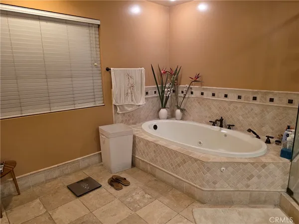 a bathroom with a white bath tub and a shower