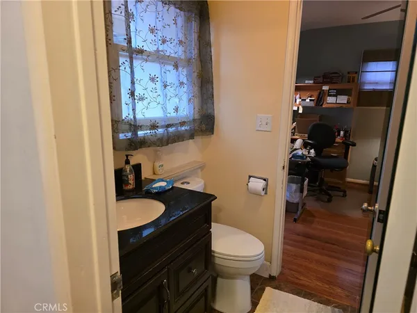 a bathroom with a toilet a sink and a mirror