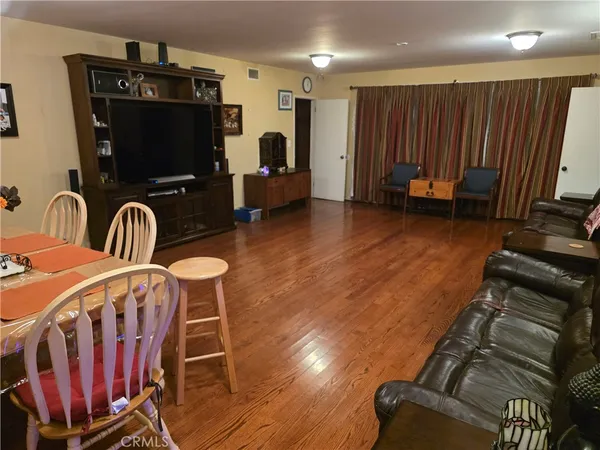 a room with furniture a flat screen tv and gym equipment