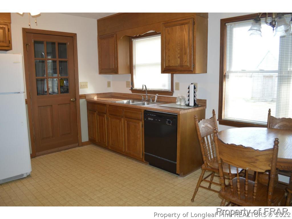 3549 Hayes Mill Road Godwin, NC 28344 - Photo 7 of 27 a kitchen with a sink cabinets and a window