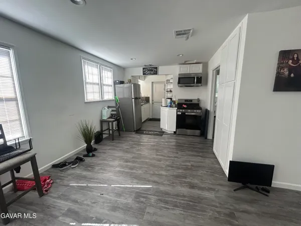 a view of a workspace with furniture and a window