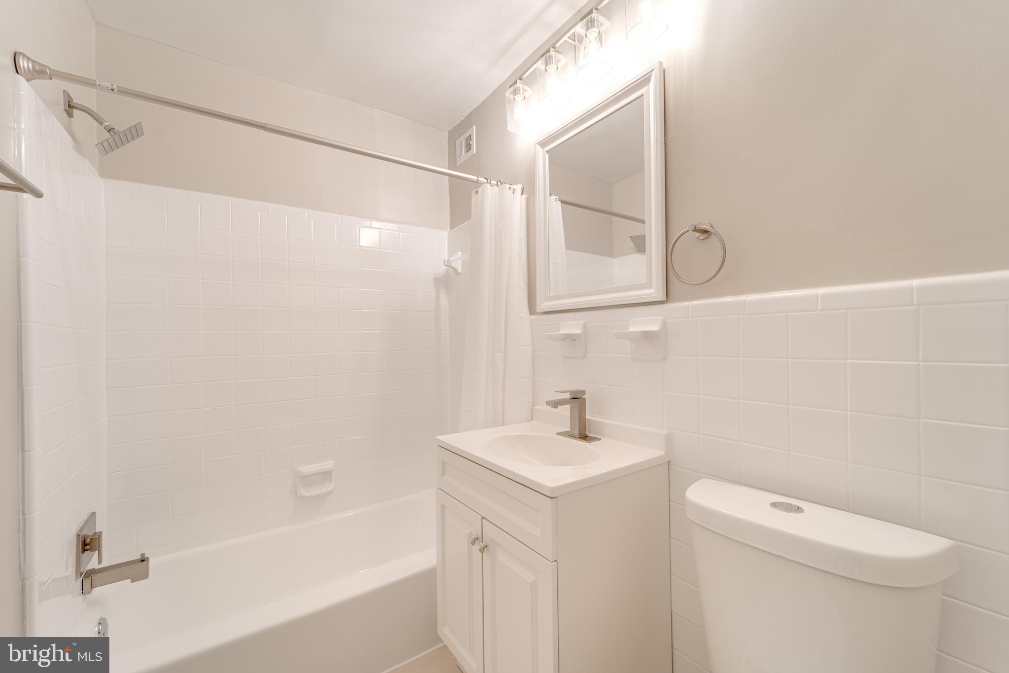 51 Skyhill Road, Unit 202 Alexandria, VA 22314 - Photo 11 of 23 a bathroom with a sink a toilet and shower