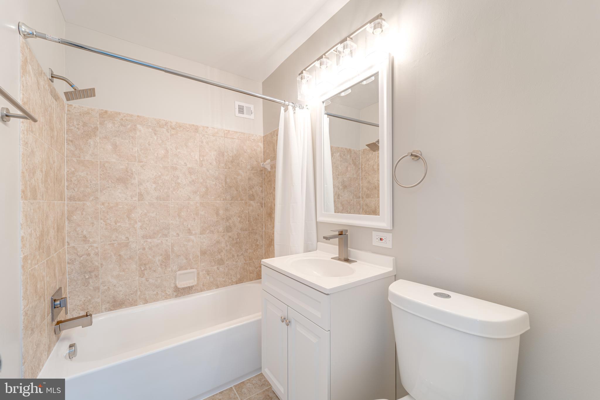 51 Skyhill Road, Unit 202 Alexandria, VA 22314 - Photo 19 of 23 a bathroom with a sink a toilet and shower