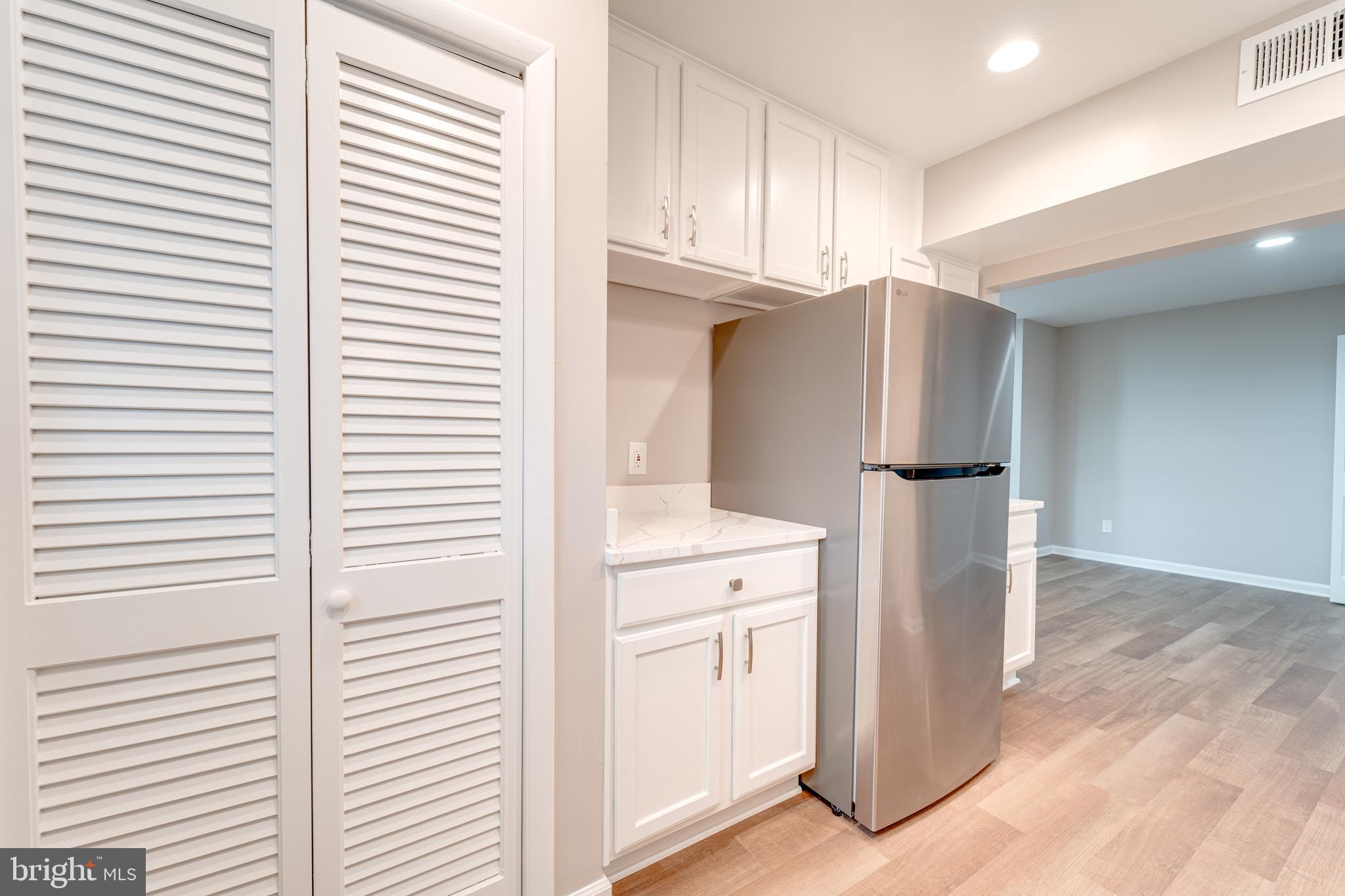51 Skyhill Road, Unit 202 Alexandria, VA 22314 - Photo 5 of 23 a kitchen with cabinets and a refrigerator