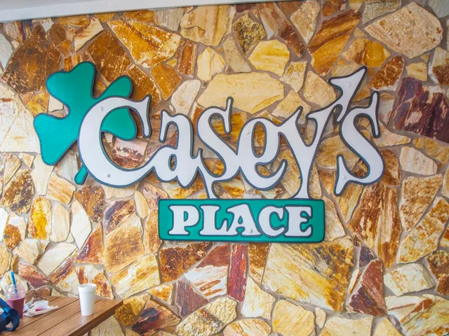 a bathroom with a sink and a sign on it