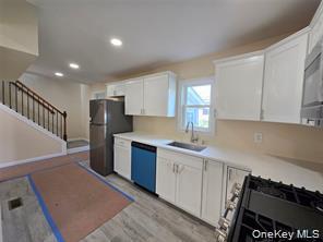 1-3 Chestnut Street Middletown, NY 10940 - Photo 6 of 19 a kitchen with stainless steel appliances a refrigerator sink and cabinets