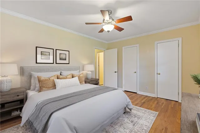 a spacious bedroom with a bed and a painting on the wall