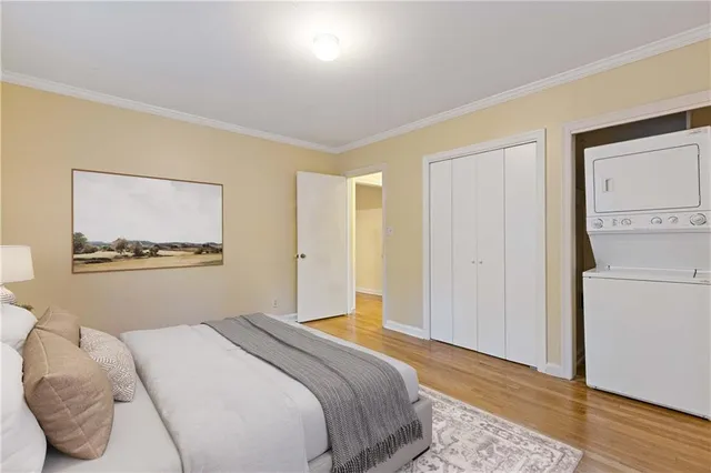 a bedroom with a bed and a painting on the wall