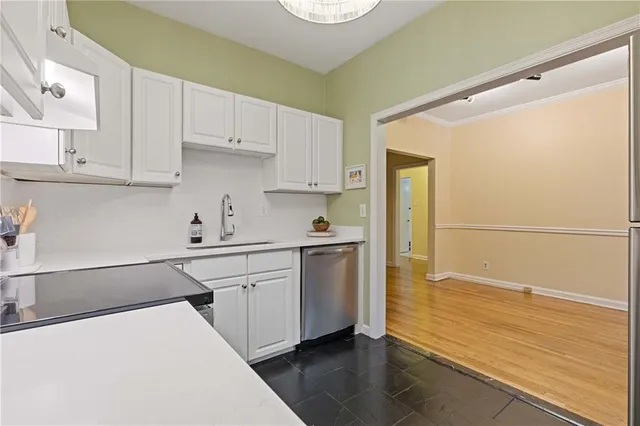 a kitchen with a sink appliances and cabinets