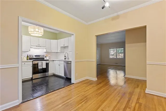a kitchen with granite countertop white cabinets and white appliances