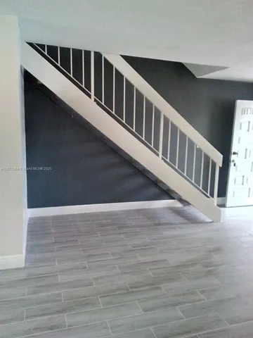 a view of staircase with wooden floor
