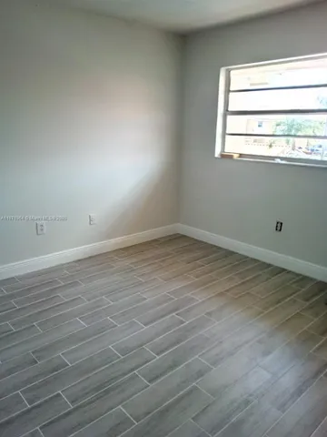 an empty room with wooden floor