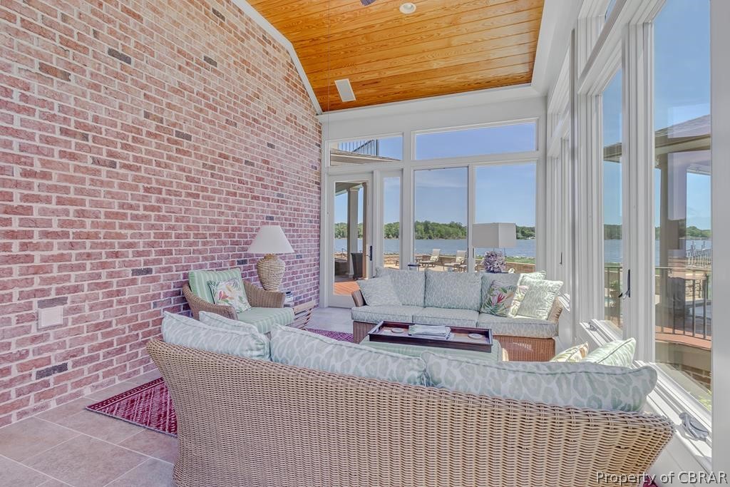 2055 Ditchley Road Kilmarnock, VA 22482 - Photo 18 of 48 Sunroom / solarium featuring a healthy amount of sunlight, a water view, wooden ceiling, and vaulted ceiling