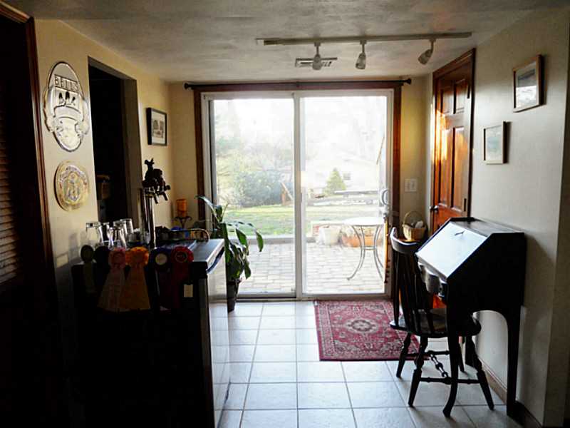 7 Seneca Street Coventry, RI 02816 - Photo 15 of 25 Den/Family/Great Room. Newer sliders lead out to the recently installed paver patio.