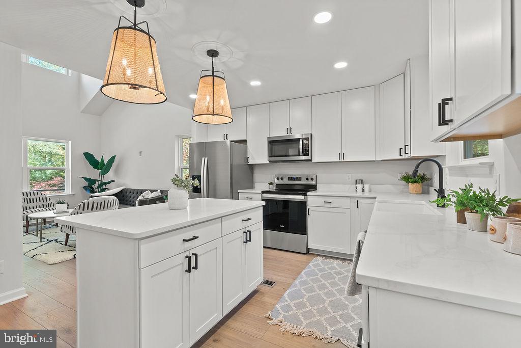 6 Willow Branch Lane Fredericksburg, VA 22405 - Photo 11 of 56 a kitchen with a sink a counter top space appliances and cabinets