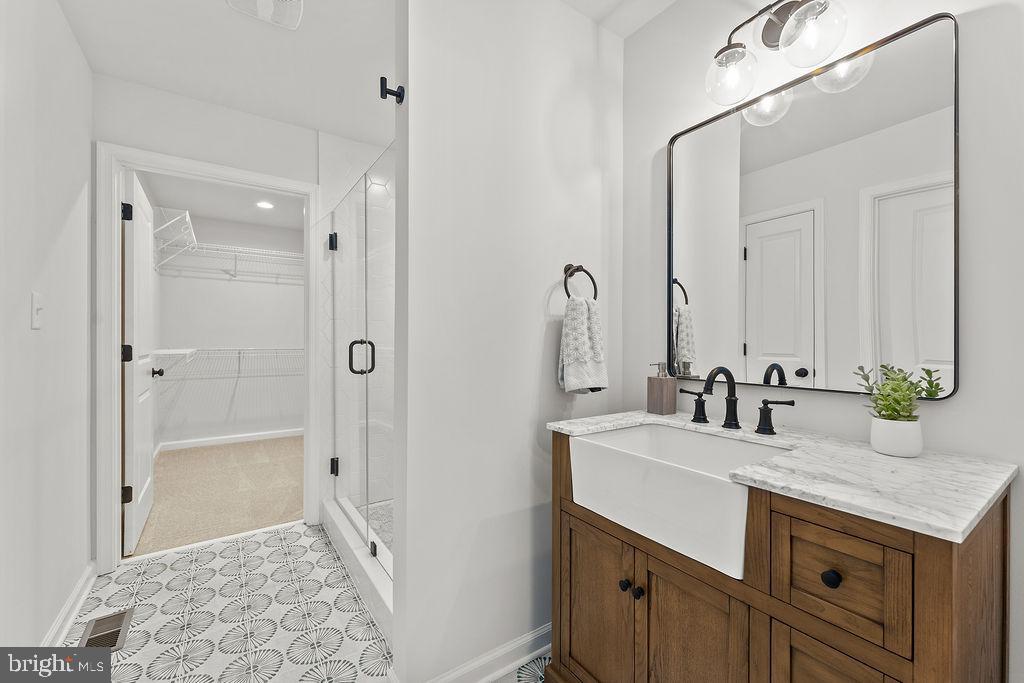 6 Willow Branch Lane Fredericksburg, VA 22405 - Photo 19 of 56 a bathroom with a granite countertop sink a mirror and a shower