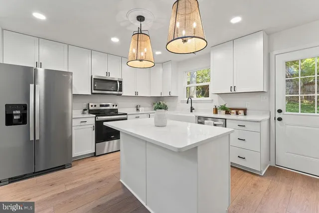 a kitchen with cabinets and window