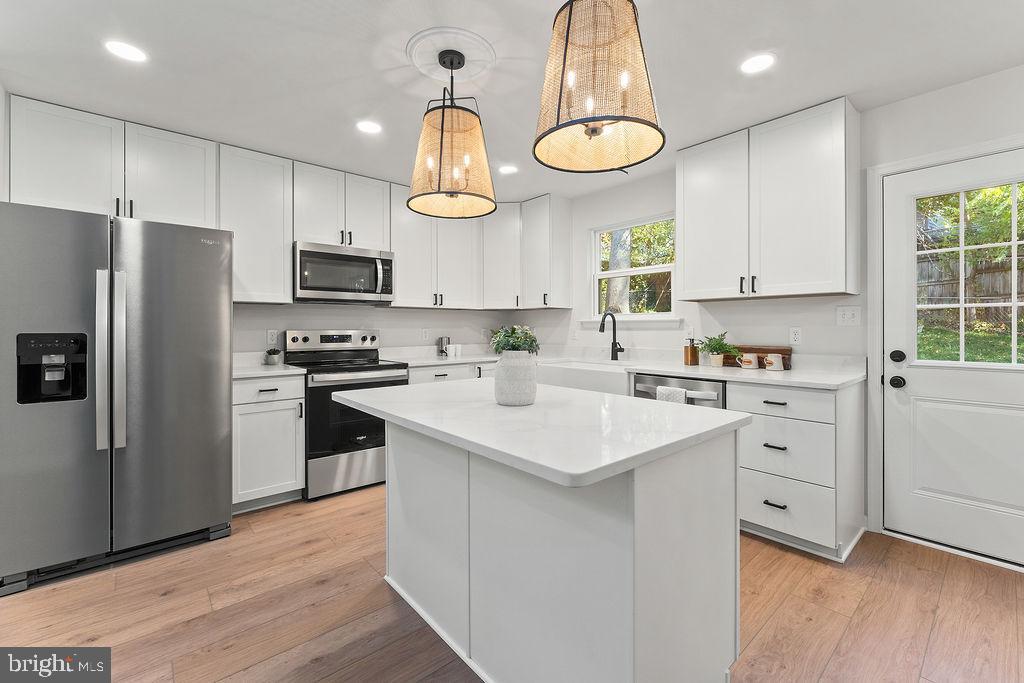 6 Willow Branch Lane Fredericksburg, VA 22405 - Photo 9 of 56 a kitchen with white cabinets stainless steel appliances and window