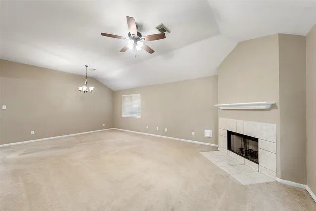 a view of an empty room with a fireplace
