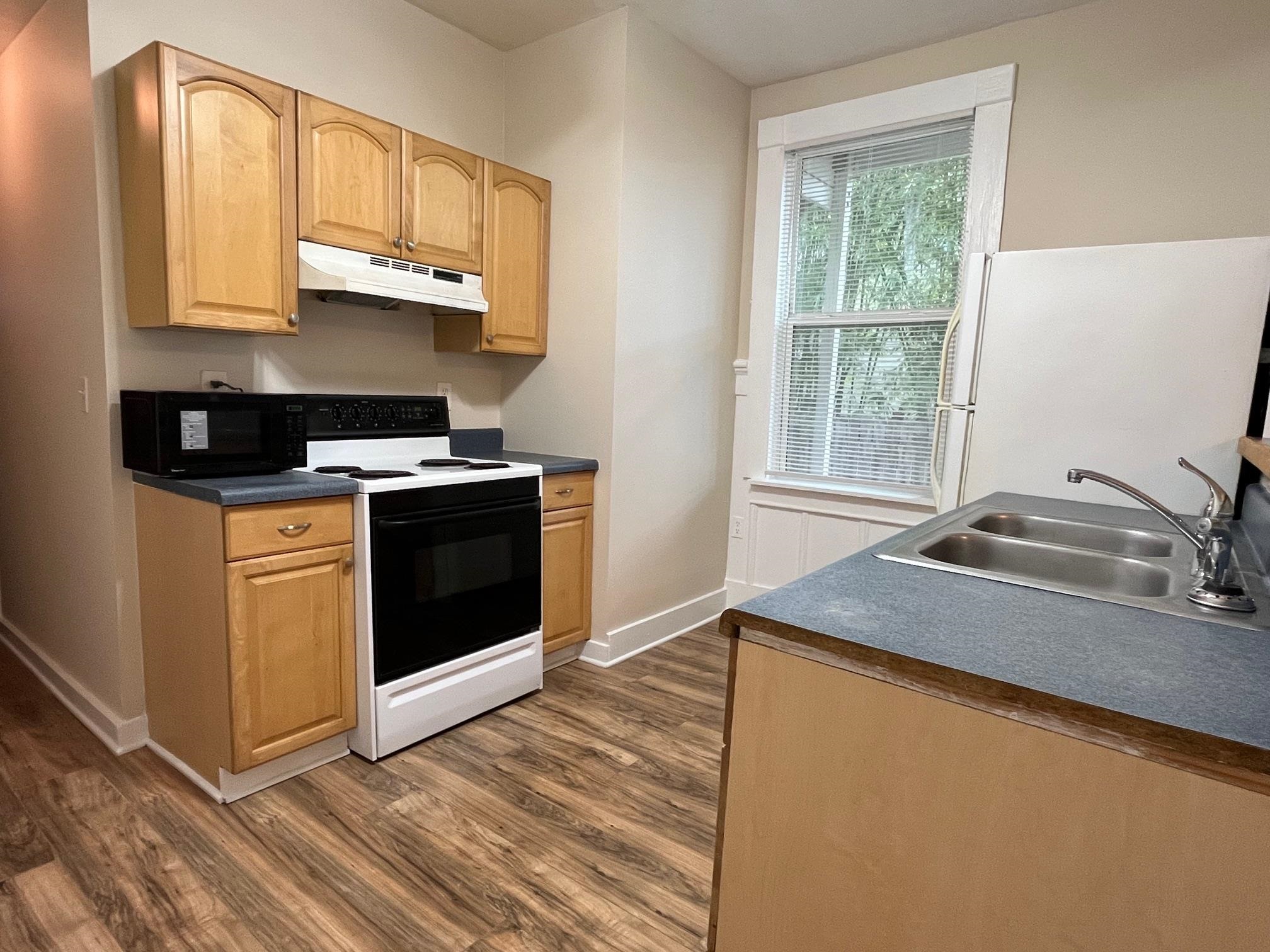 25 Desoto Place, Unit 2 St. Augustine, FL 32084 - Photo 5 of 14 a kitchen with stainless steel appliances granite countertop a sink stove and microwave