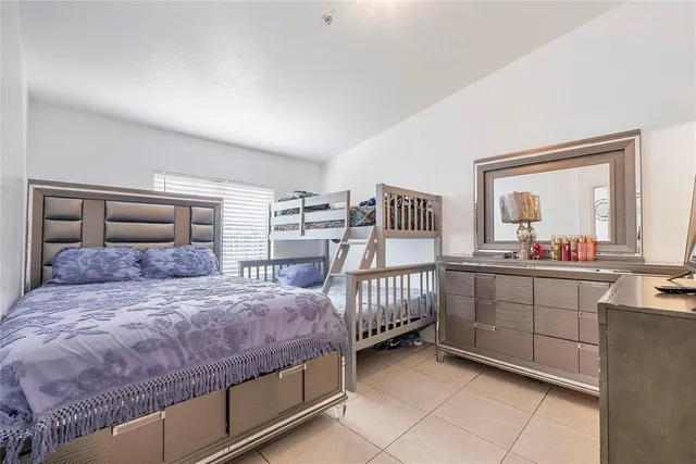 a bed sitting in a bedroom next to a window