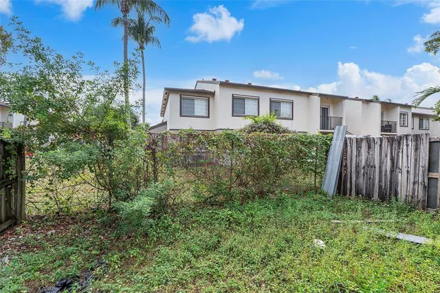 a view of a house with yard and a garden