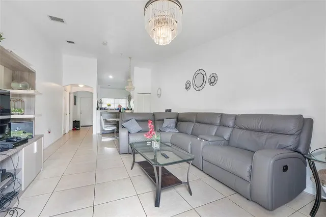 a living room with furniture a rug and a window