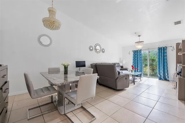a dining room with furniture and a window