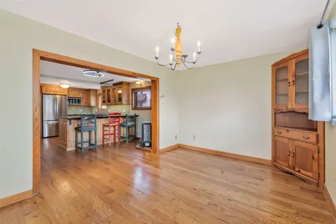 a dining room with furniture and wooden floor