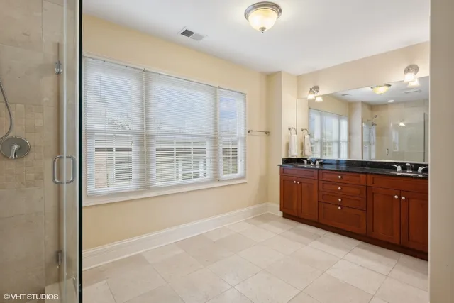 a large bathroom with a large tub shower and sink