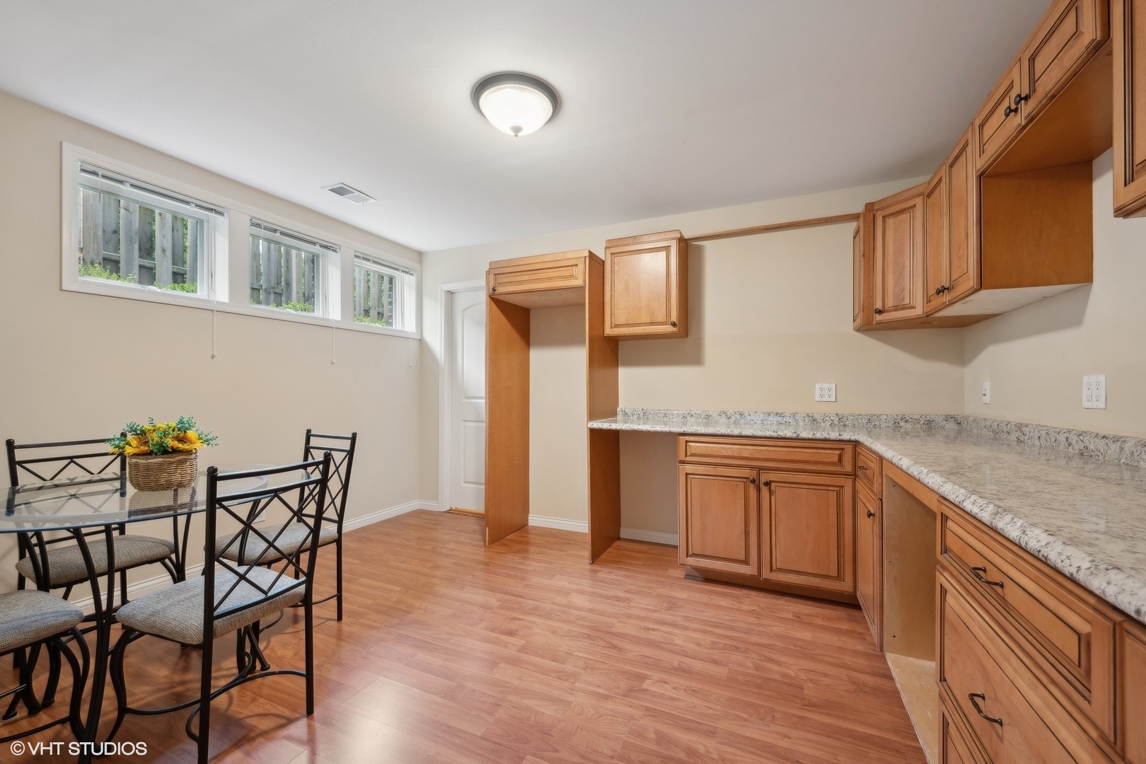 410 Green Bay Road Glencoe, IL 60022 - Photo 19 of 27 a kitchen with granite countertop chair and wooden cabinets