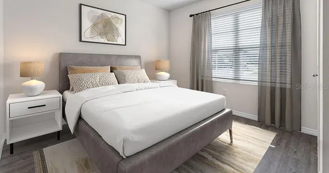 a bedroom with a bed and a window