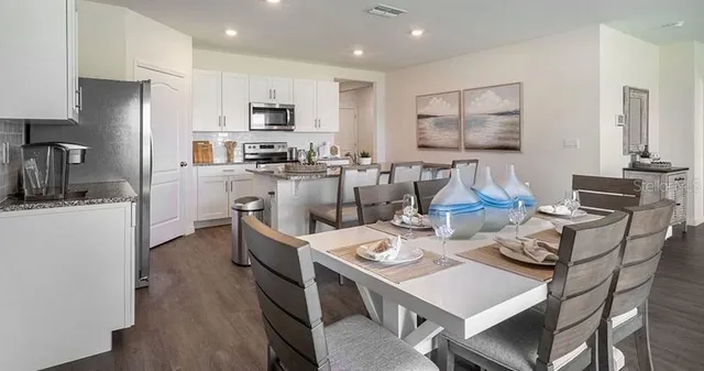 a kitchen that has a table and chairs in it