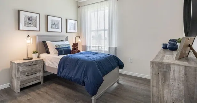 a bedroom with a bed and a window