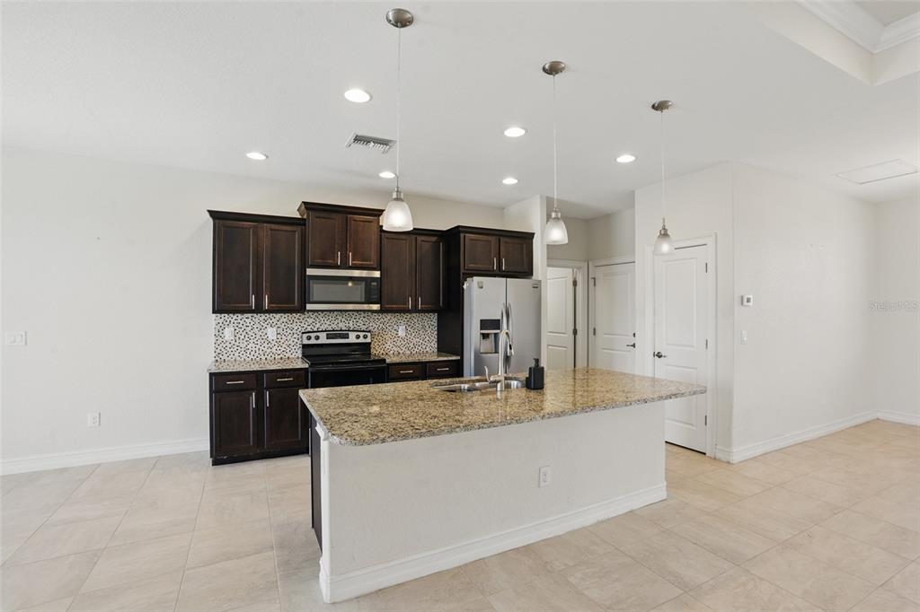 7505 Carissa Punta Gorda, FL 33955 - Photo 17 of 57 a large kitchen with a large counter top stainless steel appliances and cabinets
