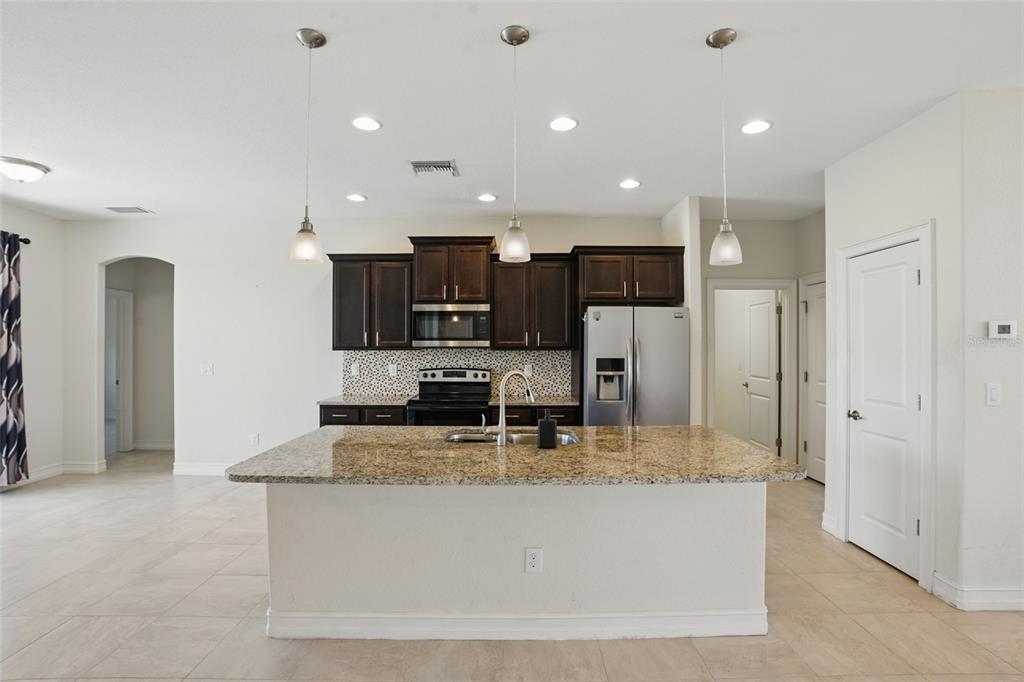 7505 Carissa Punta Gorda, FL 33955 - Photo 18 of 57 a kitchen with kitchen island sink refrigerator and stove