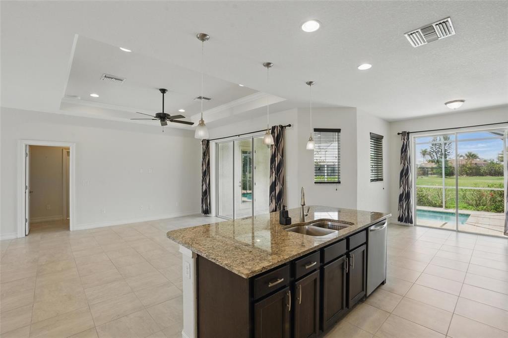 7505 Carissa Punta Gorda, FL 33955 - Photo 20 of 57 a kitchen with granite countertop a sink and a refrigerator
