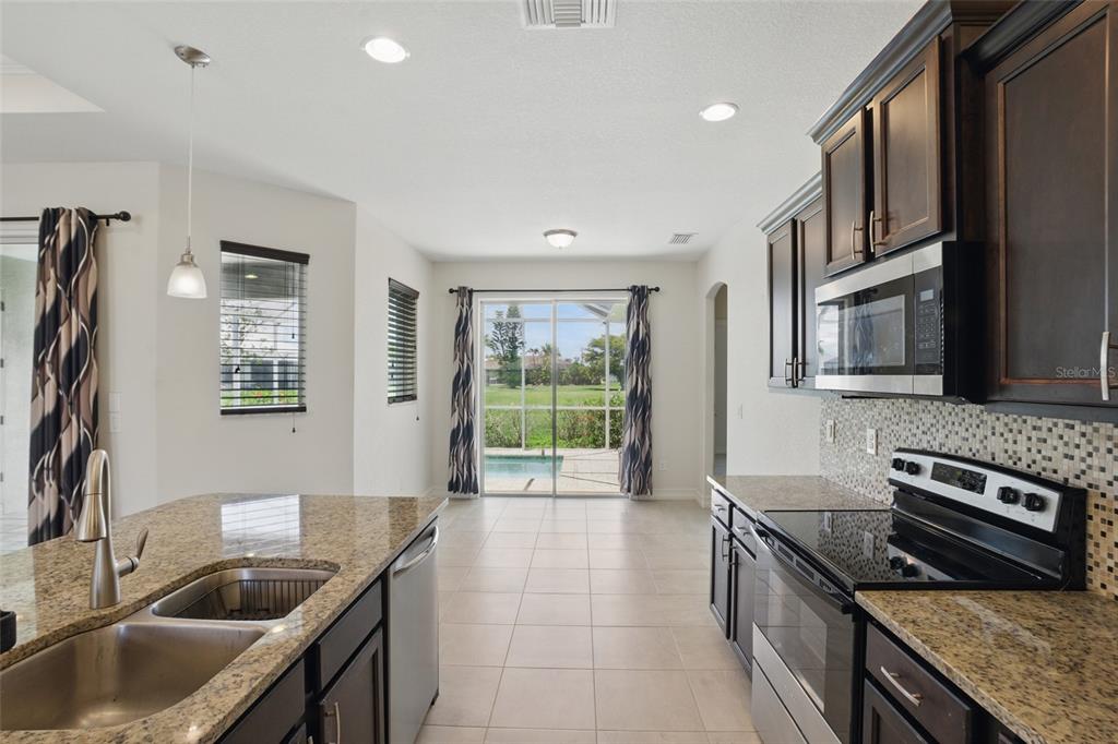7505 Carissa Punta Gorda, FL 33955 - Photo 21 of 57 a kitchen with stainless steel appliances granite countertop a sink stove and cabinets