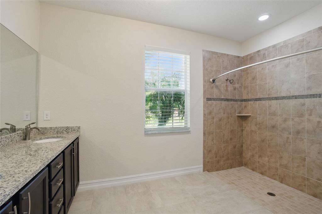 7505 Carissa Punta Gorda, FL 33955 - Photo 30 of 57 a bathroom with a granite countertop sink a shower and a mirror
