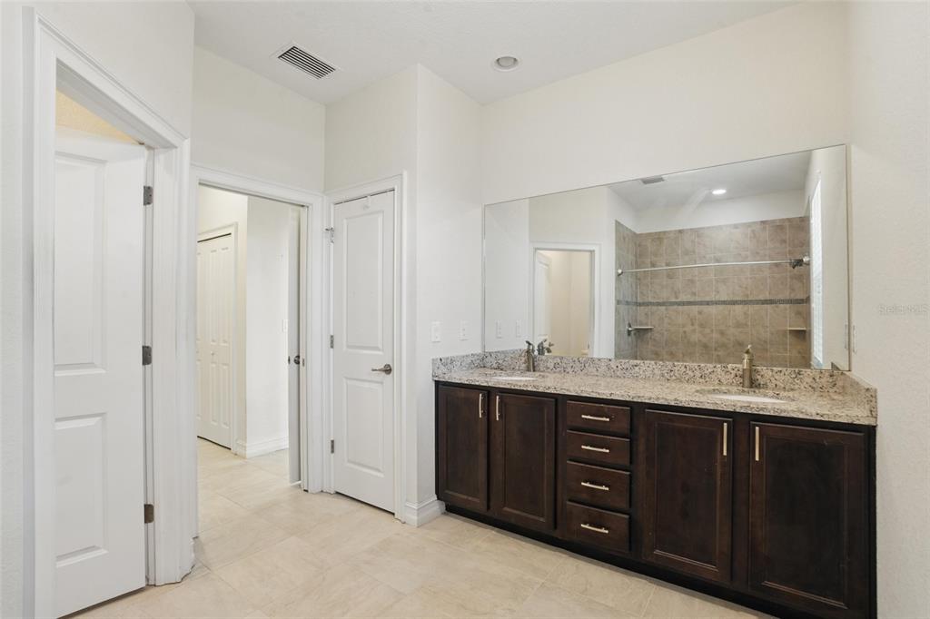 7505 Carissa Punta Gorda, FL 33955 - Photo 31 of 57 a spacious bathroom with a granite countertop sink mirror and double
