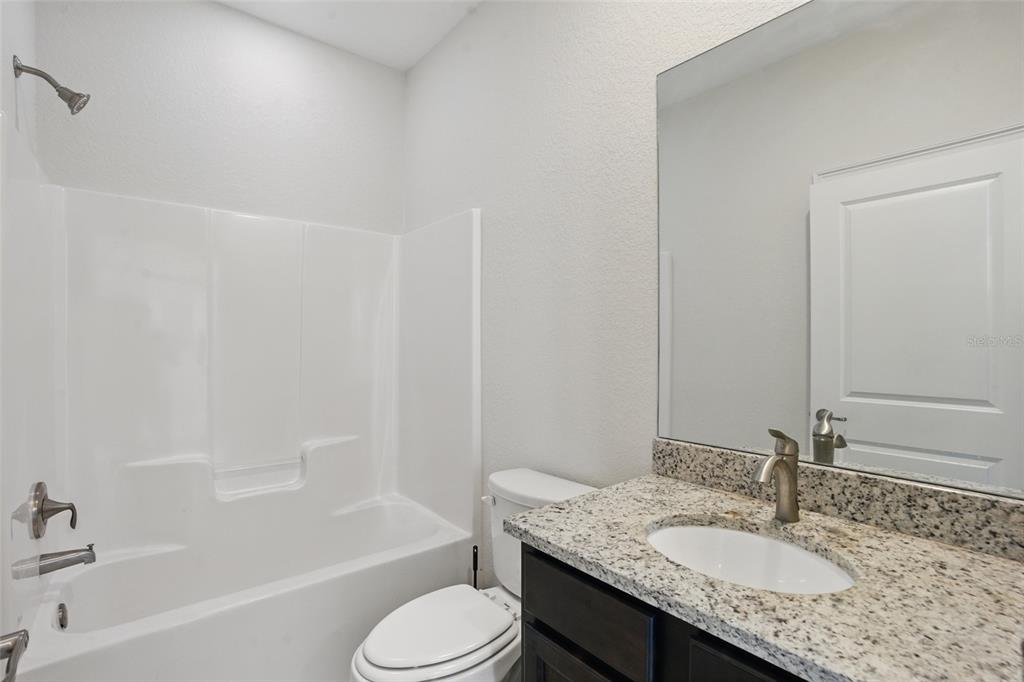 7505 Carissa Punta Gorda, FL 33955 - Photo 36 of 57 a bathroom with a granite countertop sink toilet and shower