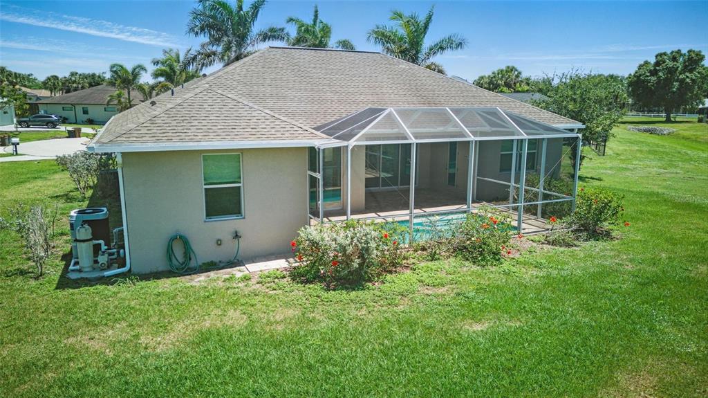 7505 Carissa Punta Gorda, FL 33955 - Photo 51 of 57 a house with green field in front of it